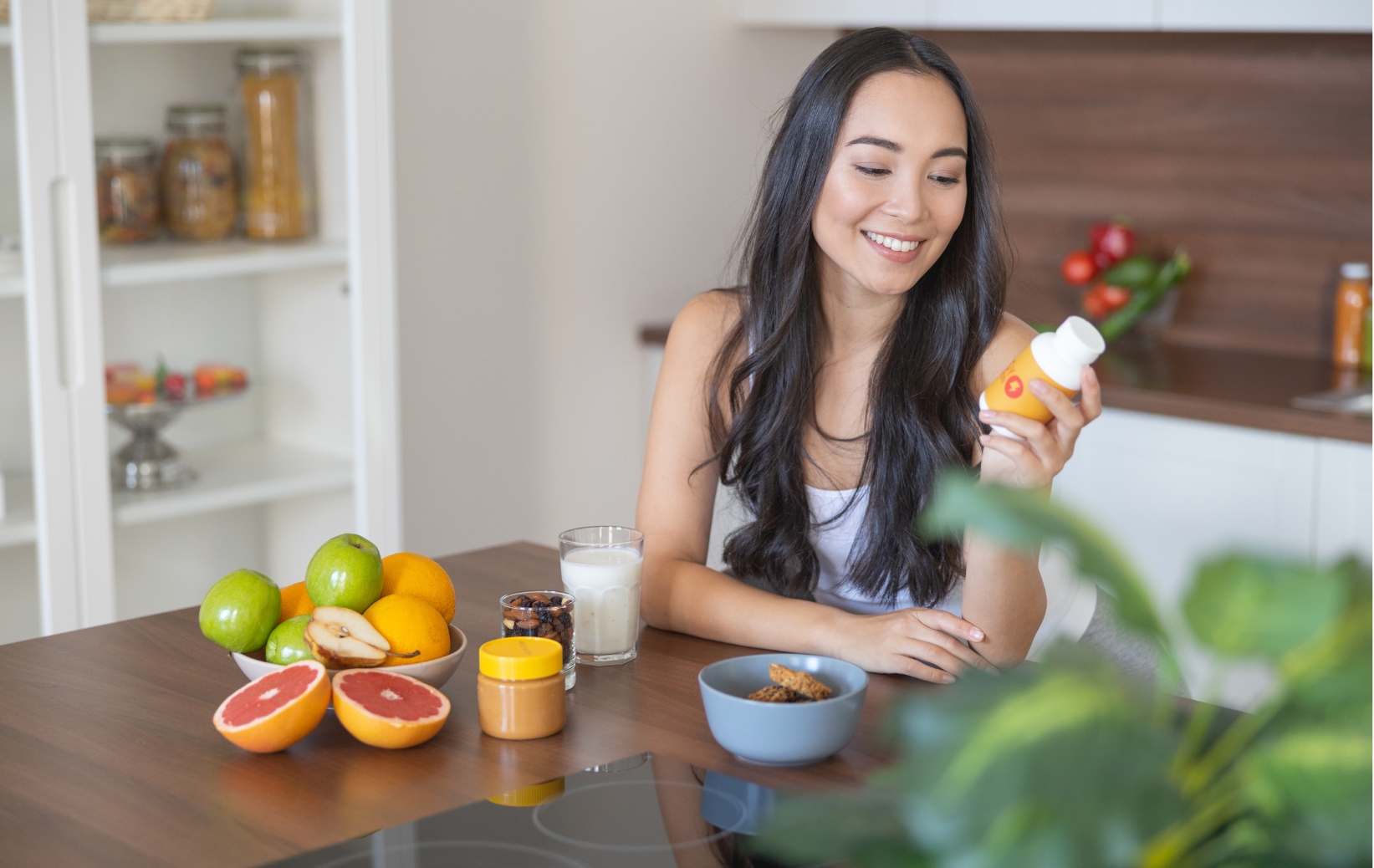 Woman holding a turmeric supplement