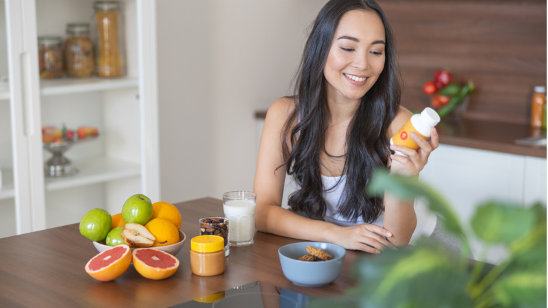 Woman holding a turmeric supplement