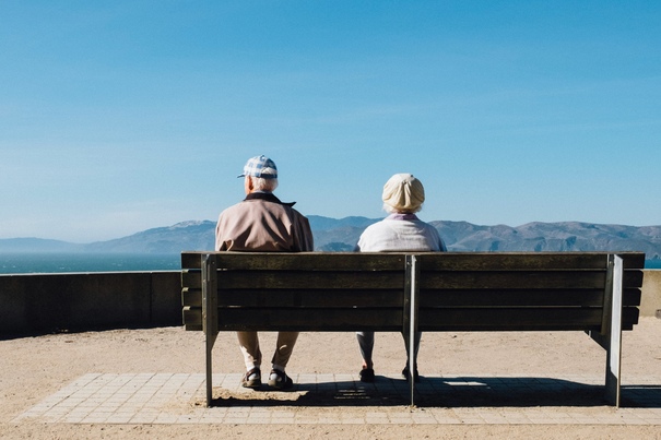 older couple on bench staring into the mountains - jinfiniti precision medicine