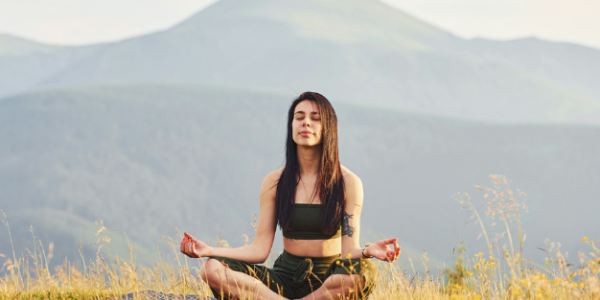 Homepage 28 A woman meditating in a field